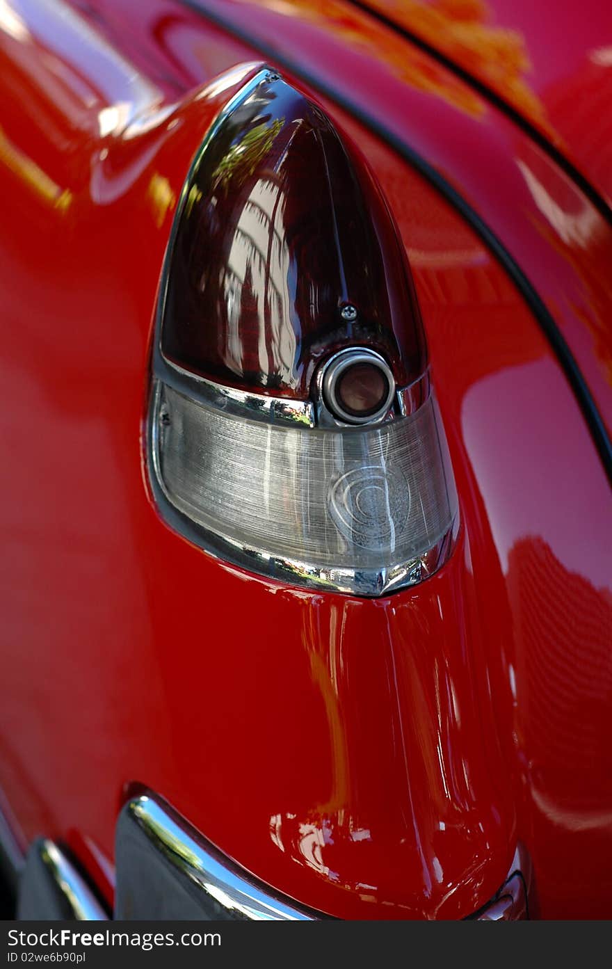 Detail of a Taillight of a Shiny, Red Classic American Car. Detail of a Taillight of a Shiny, Red Classic American Car