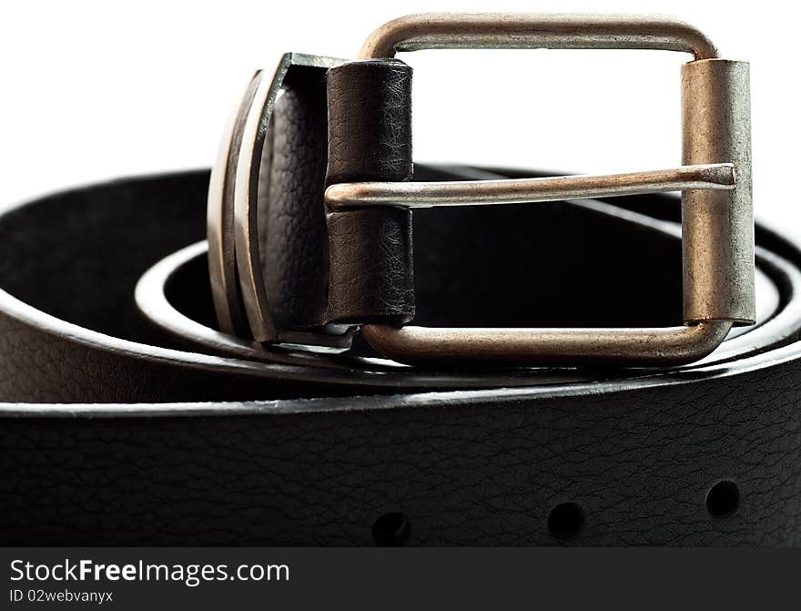 Close up view of a black leather belt on a white background