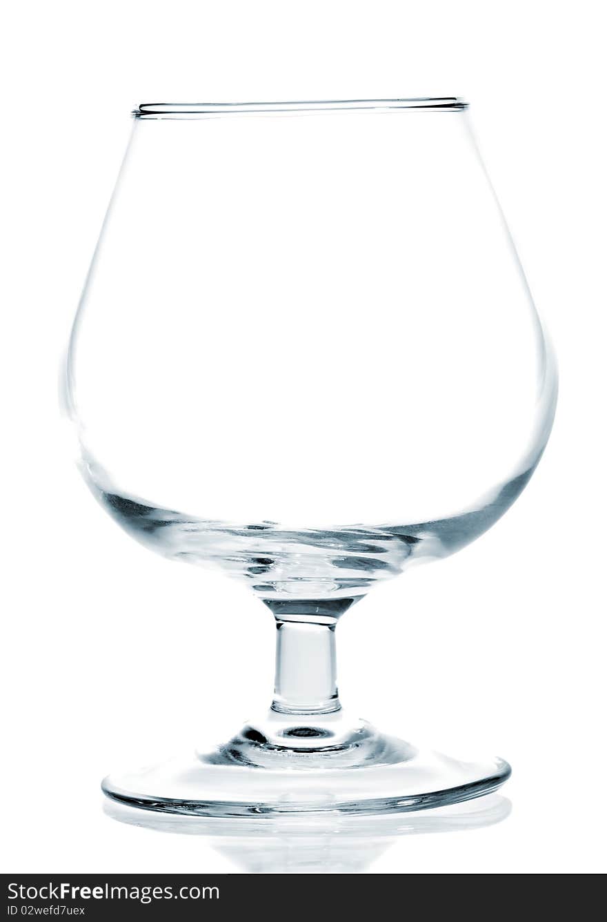 Empty wine glass on a white background with reflections on the floor