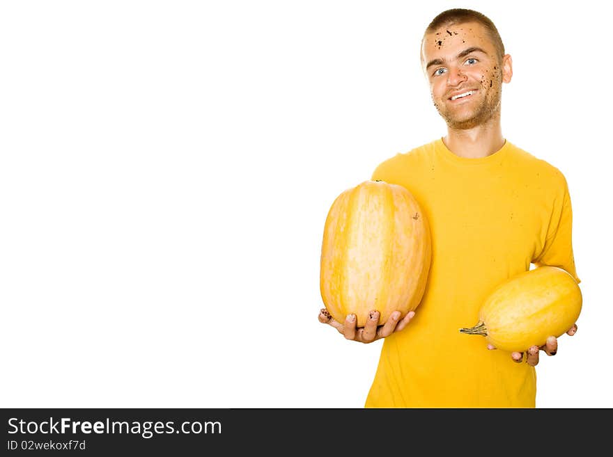 Handsome young man holds a lot of different pumpkin in his hands. Lots of copyspace and room for text on this isolate. Handsome young man holds a lot of different pumpkin in his hands. Lots of copyspace and room for text on this isolate