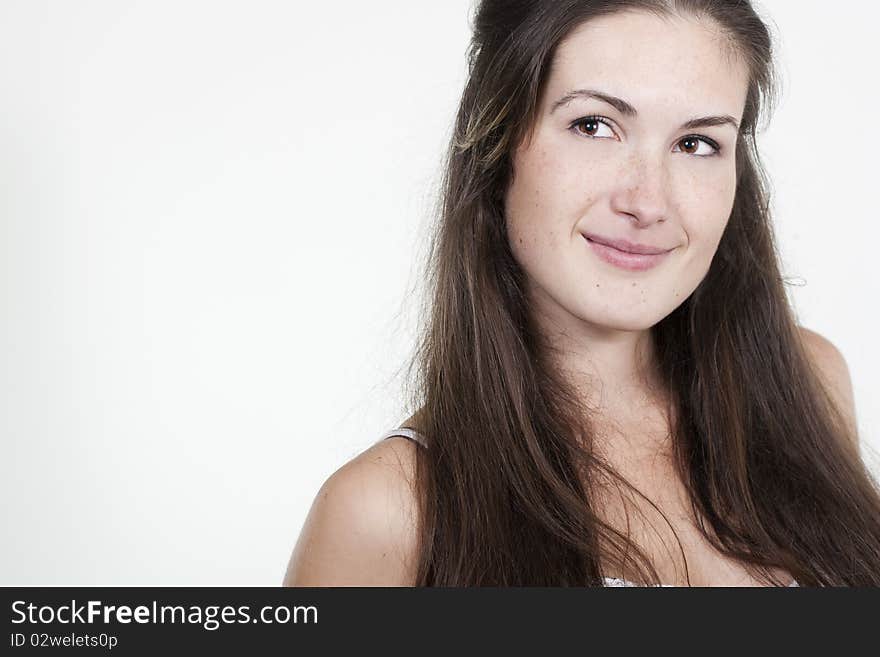 Portrait of beautiful young smiling girl with freckles, isolated on white background