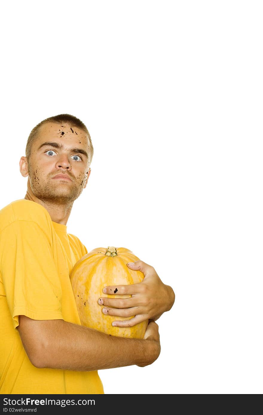 Young man squeezes with both hands a pumpkin face and hands stained the ground. Approximation of Halloween. Isolated on a white background