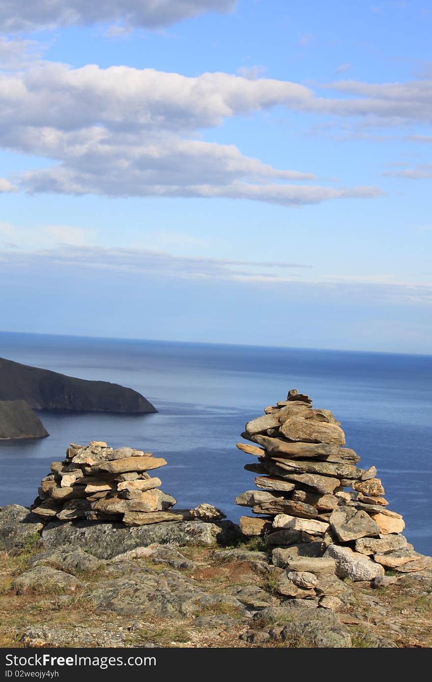 Landscape,view from hill on Baikal.Siberia. A conglomeration of stones made by shaman. Landscape,view from hill on Baikal.Siberia. A conglomeration of stones made by shaman.