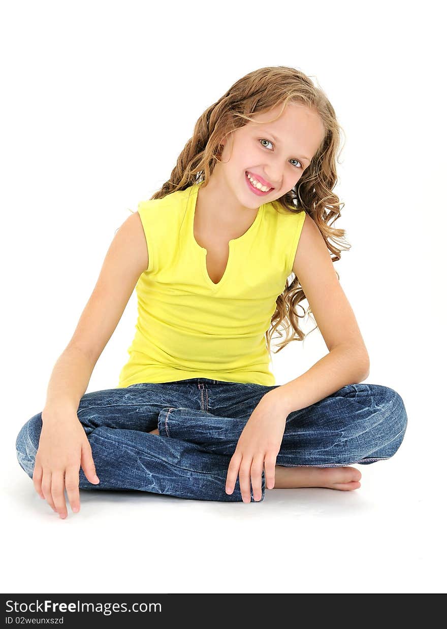 Beautiful 11 years old girl sitting on the floor and smiling. Beautiful 11 years old girl sitting on the floor and smiling