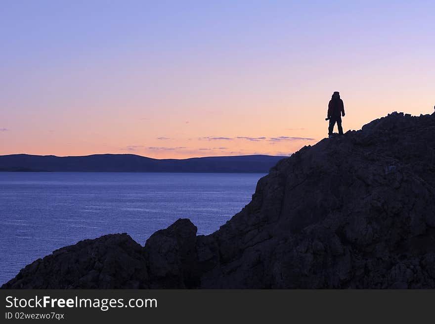 Silhouette of a photographer at daybreak on the top of mountains in Tibet.