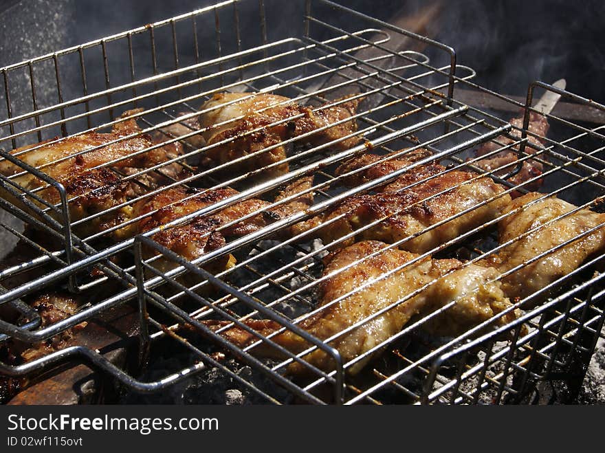 Grilled chicken on the barbeque close-up