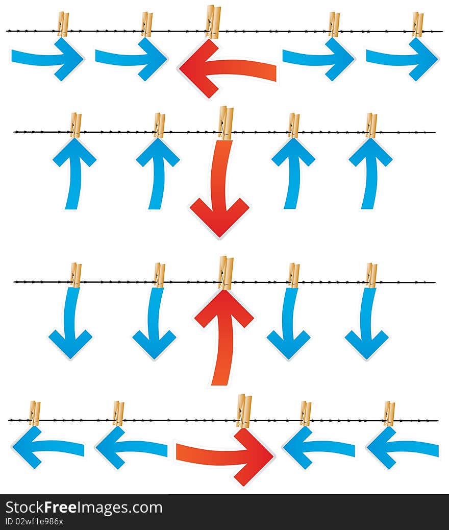 Differently directed red and dark blue arrows by means of clothespins hang on a barbed wire