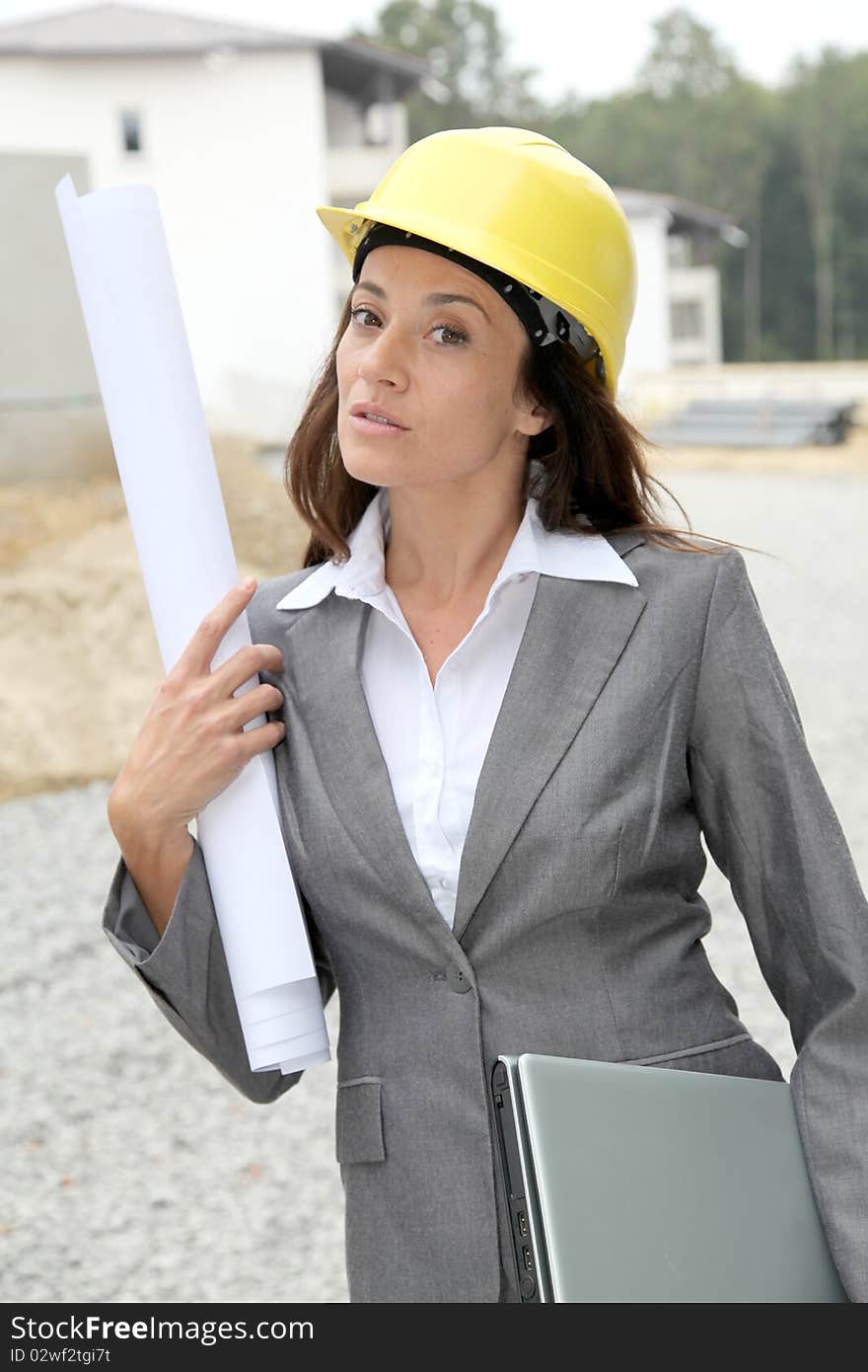 Businessman with helmet checking site under construction. Businessman with helmet checking site under construction