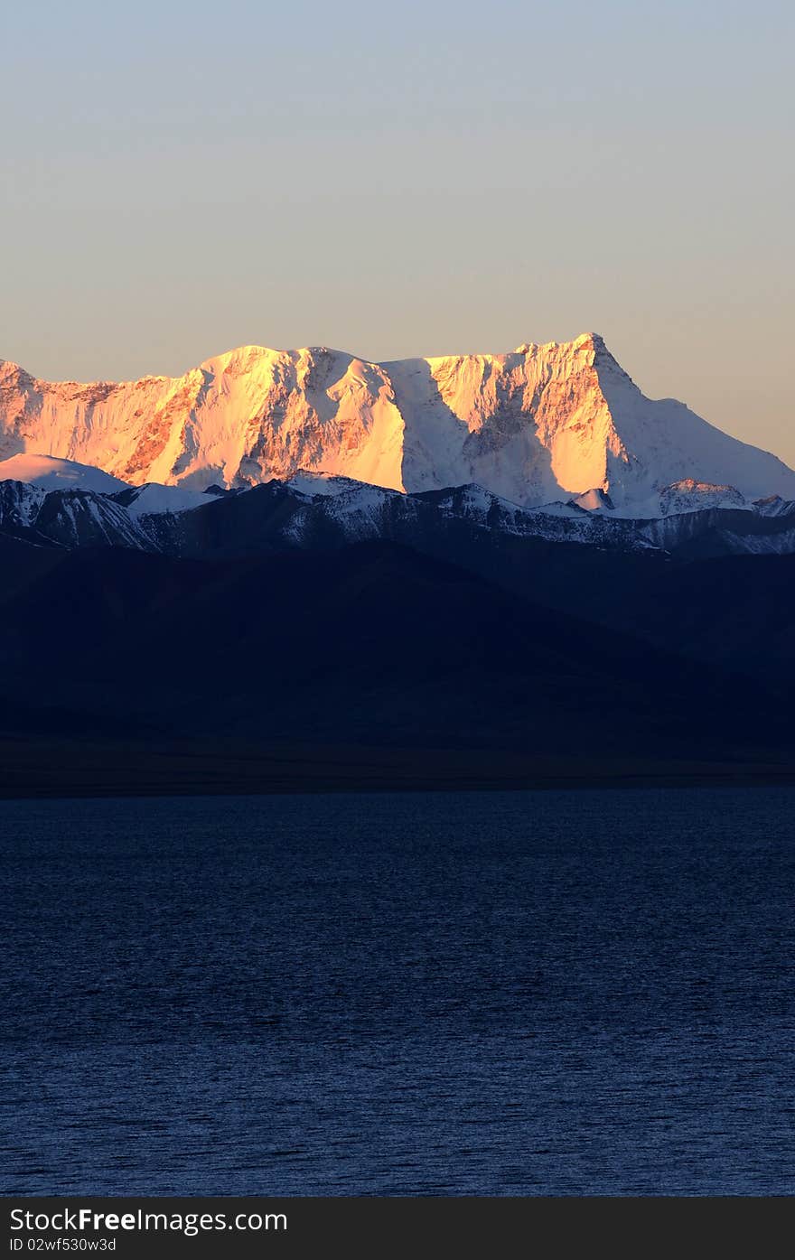 Scenery of snow mountains in Tibet at sunrise.