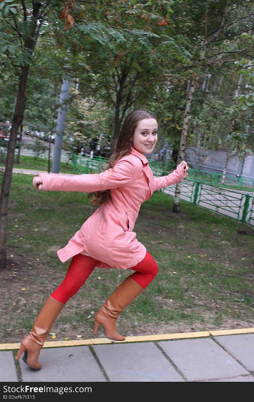 Beauty happy woman in red dress is running. Beauty happy woman in red dress is running