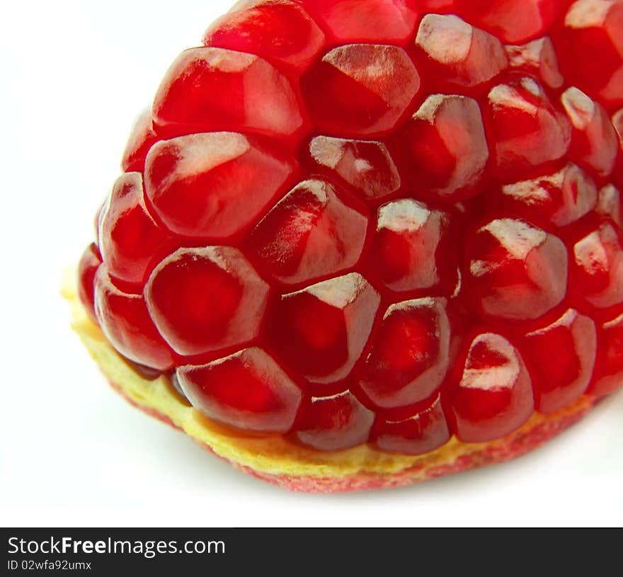 Segment of a ripe pomegranate on a white background close up