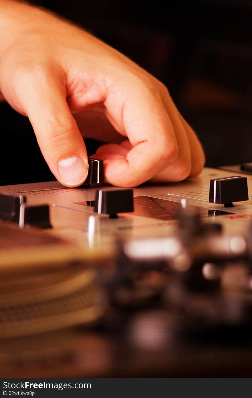 Hand of a dj adjusting the crossfader