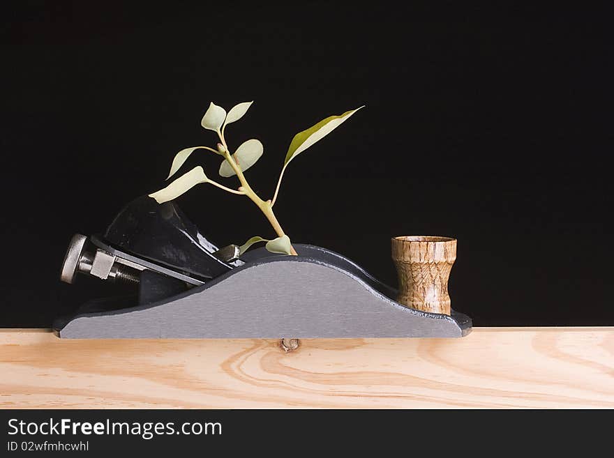 Handplane destroying a young tree on a black background. Handplane destroying a young tree on a black background.