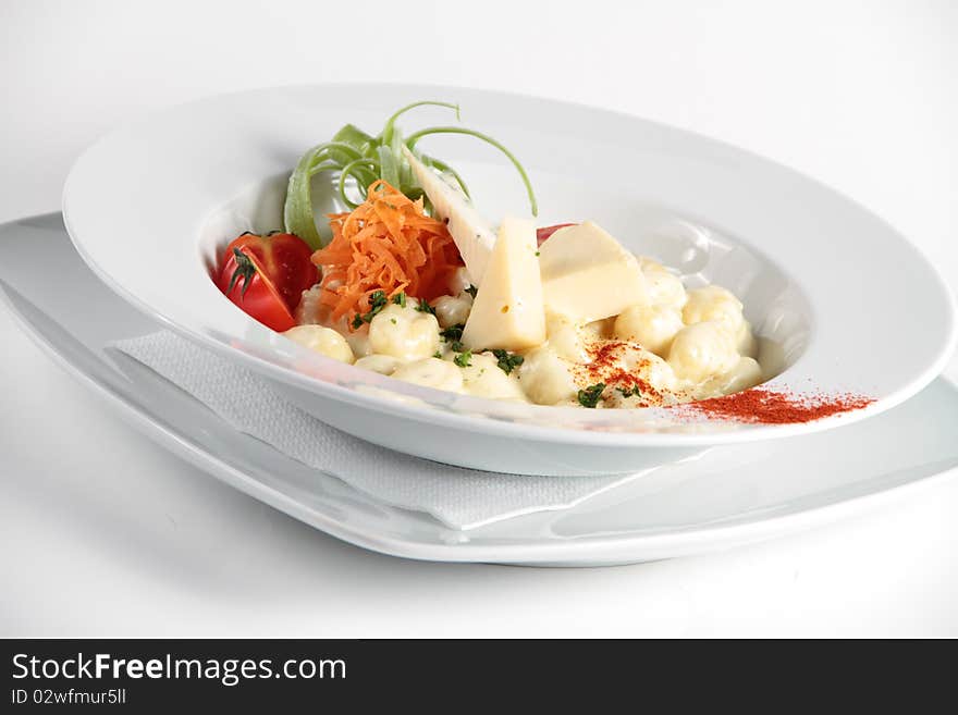 Pasta served with cheese and nicely decorated in a white plate. Pasta served with cheese and nicely decorated in a white plate