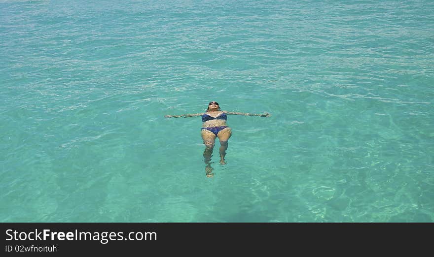 Girl swimming in the clear blue sea