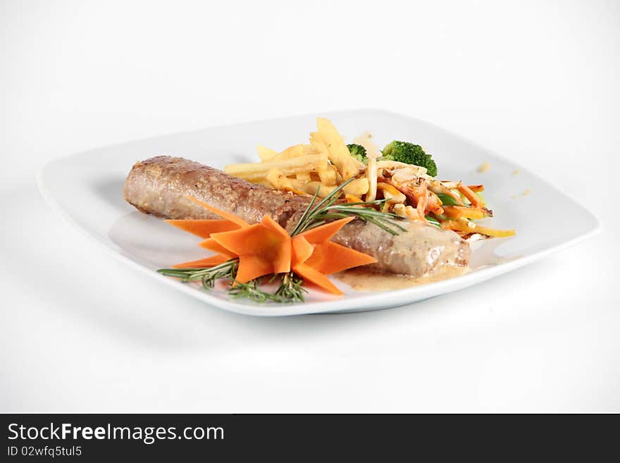 Meat role served with vegetables on a plate