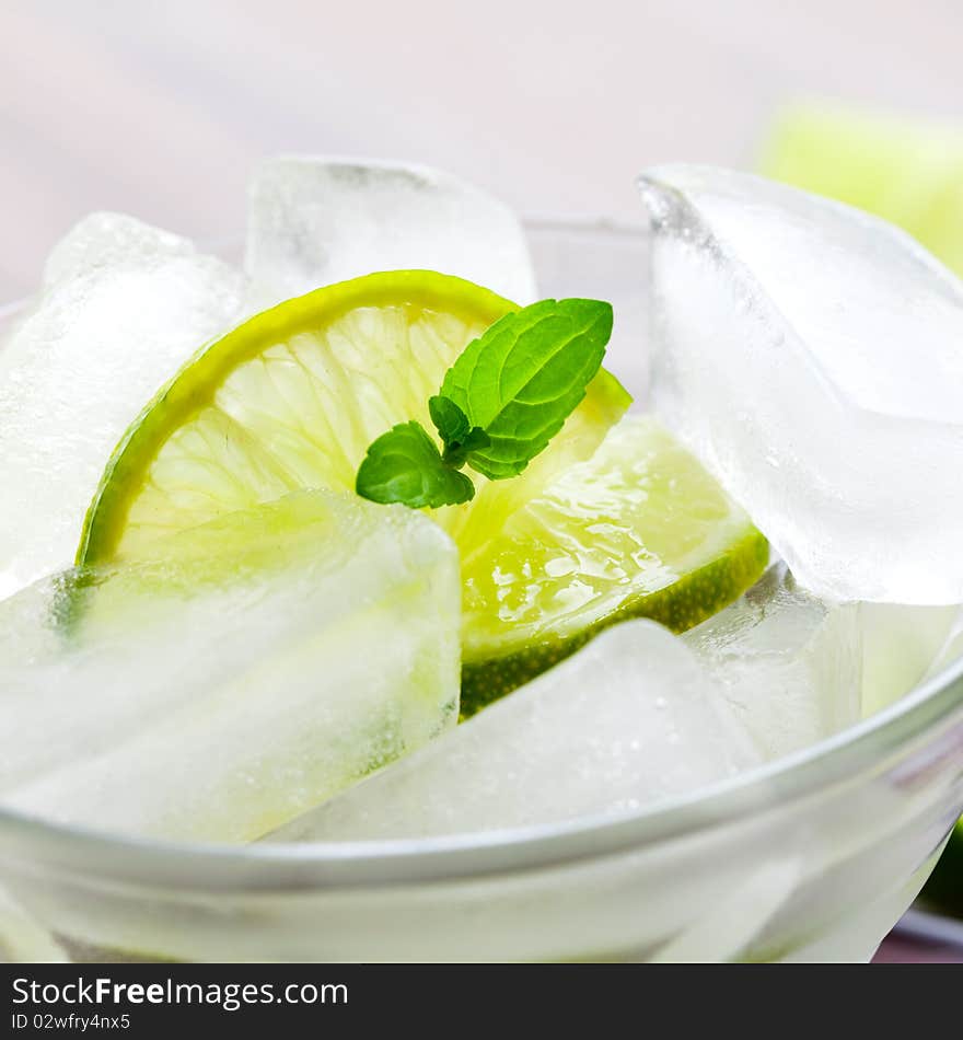 Ice cubes in glass with lime slices. Ice cubes in glass with lime slices