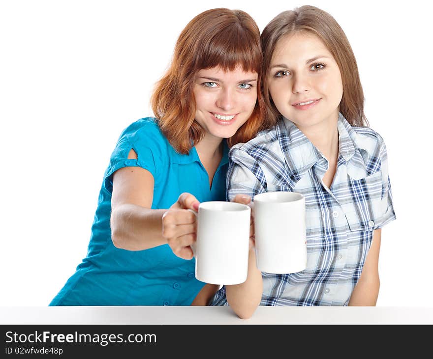 Two teen-girls are drinking tea