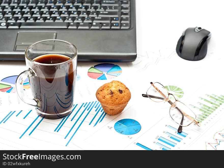 Business still-life with diagrams, glasses, coffee, cake and notebook. Business still-life with diagrams, glasses, coffee, cake and notebook