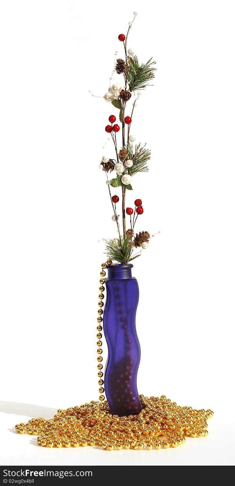 Christmas decoration in colored glass vase on white background