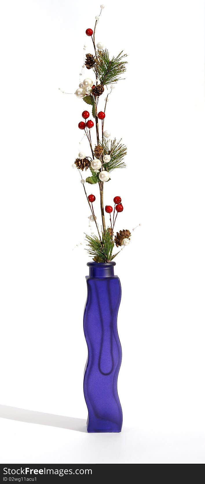 Christmas decoration in colored glass vase on white background