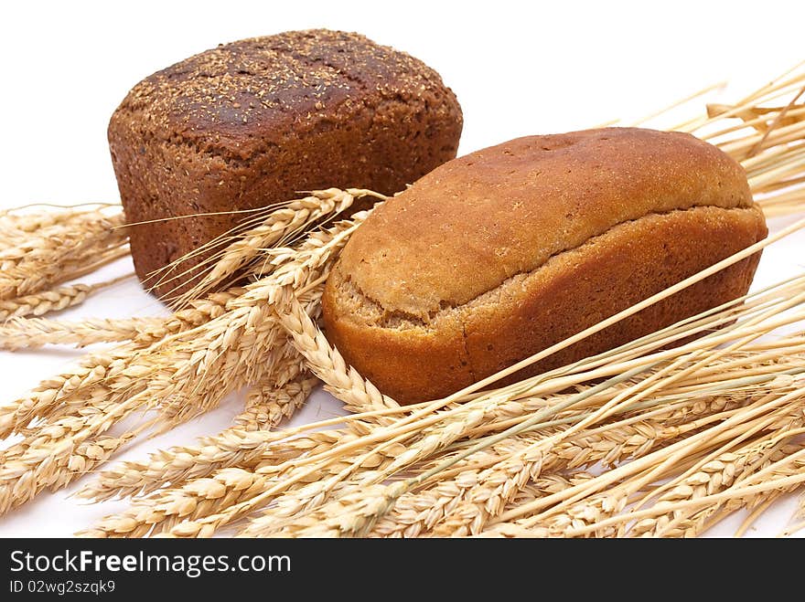 Bread with wheat and ears on white