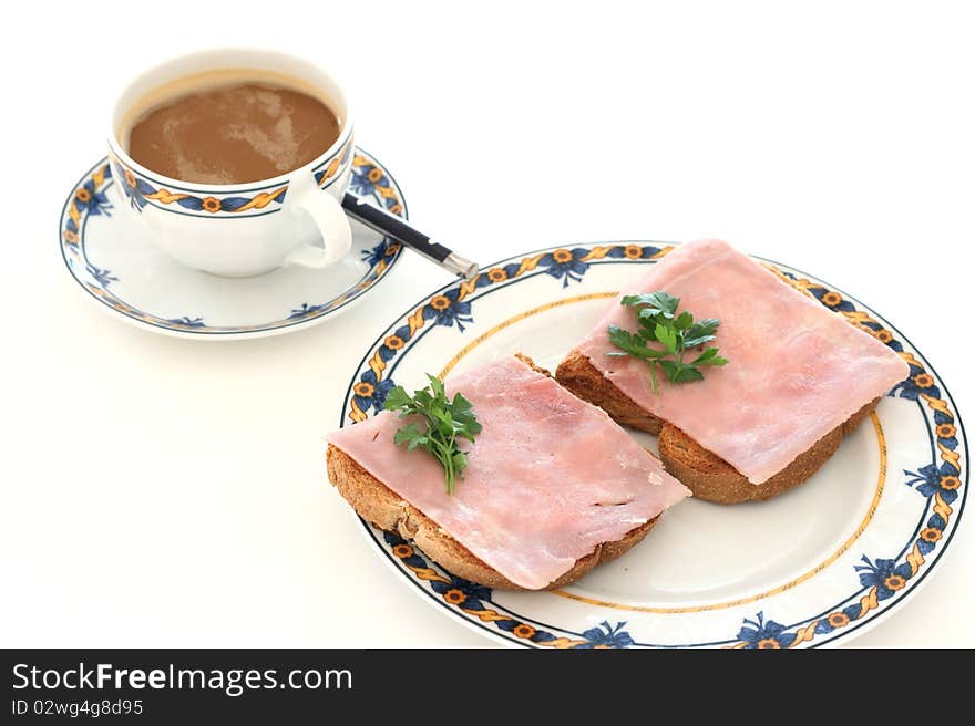 Toasts with ham and a cup of coffee with cream