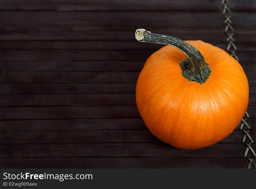 Pumpkin on wooden tray, copy space at left