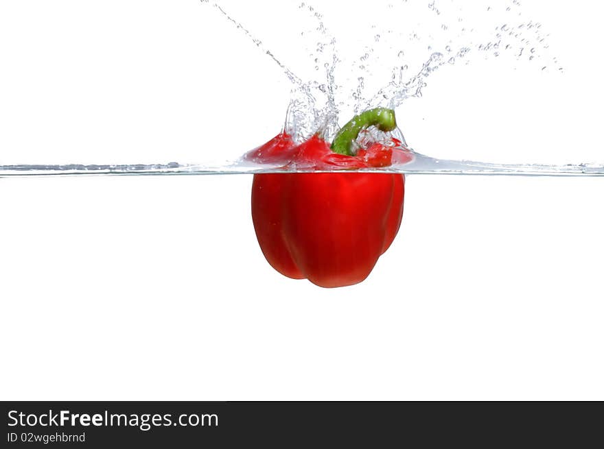 Fresh Red Bell Pepper splashing into water