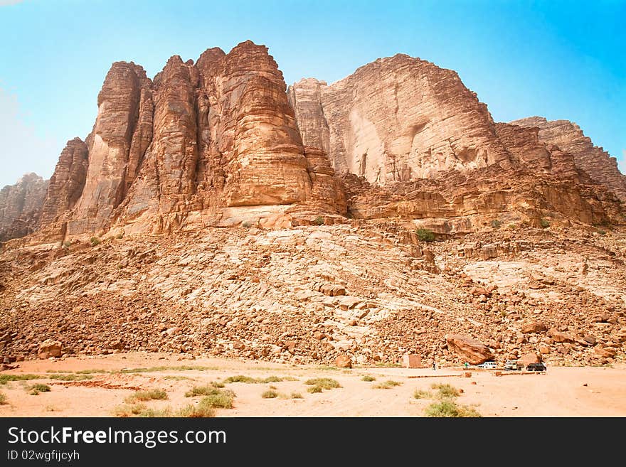 Rock hills above the famous Lawrence Spring, named after Lawrence of Arabia, Wadi Rum, UNESCO World Heritage Site in Jordan. Rock hills above the famous Lawrence Spring, named after Lawrence of Arabia, Wadi Rum, UNESCO World Heritage Site in Jordan.