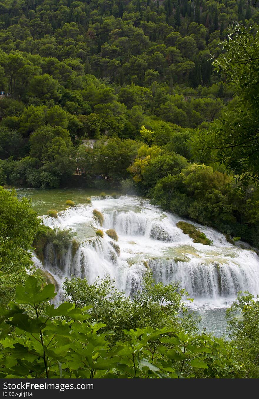 View of the waterfall surrounded by trees from the top of