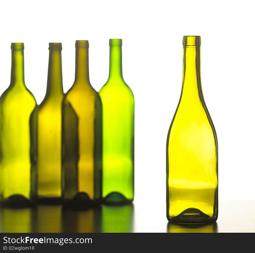 group of five green wine bottles