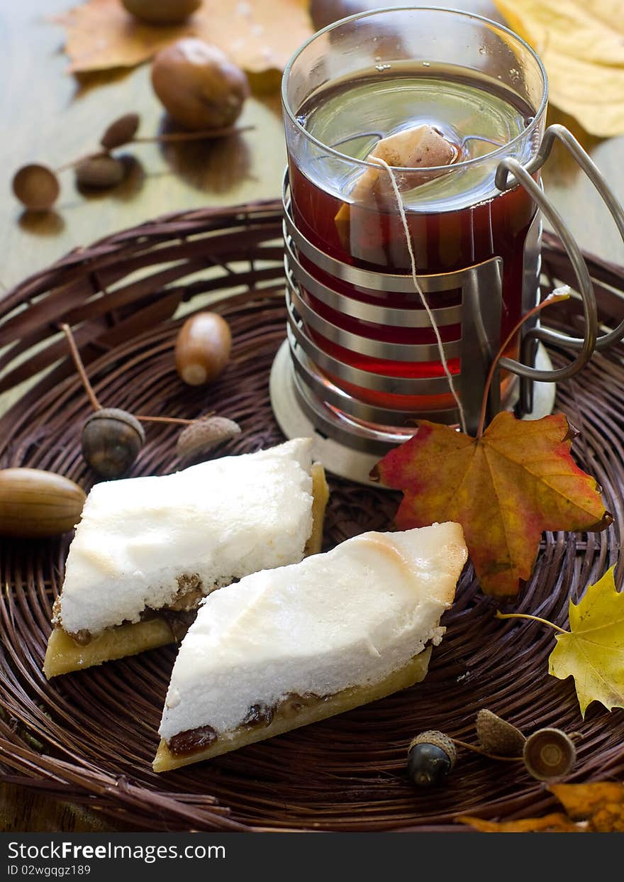 Cake with raisins in a basket with tea in the background. Cake with raisins in a basket with tea in the background