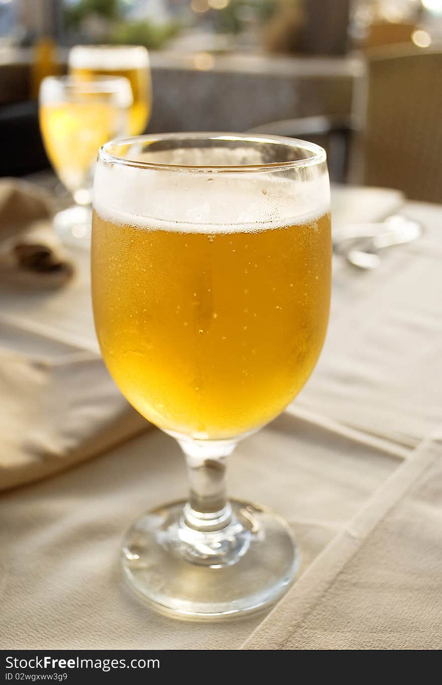 Glass beer on the table in restaurant.