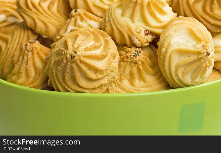 Green bowl with sweet cookies