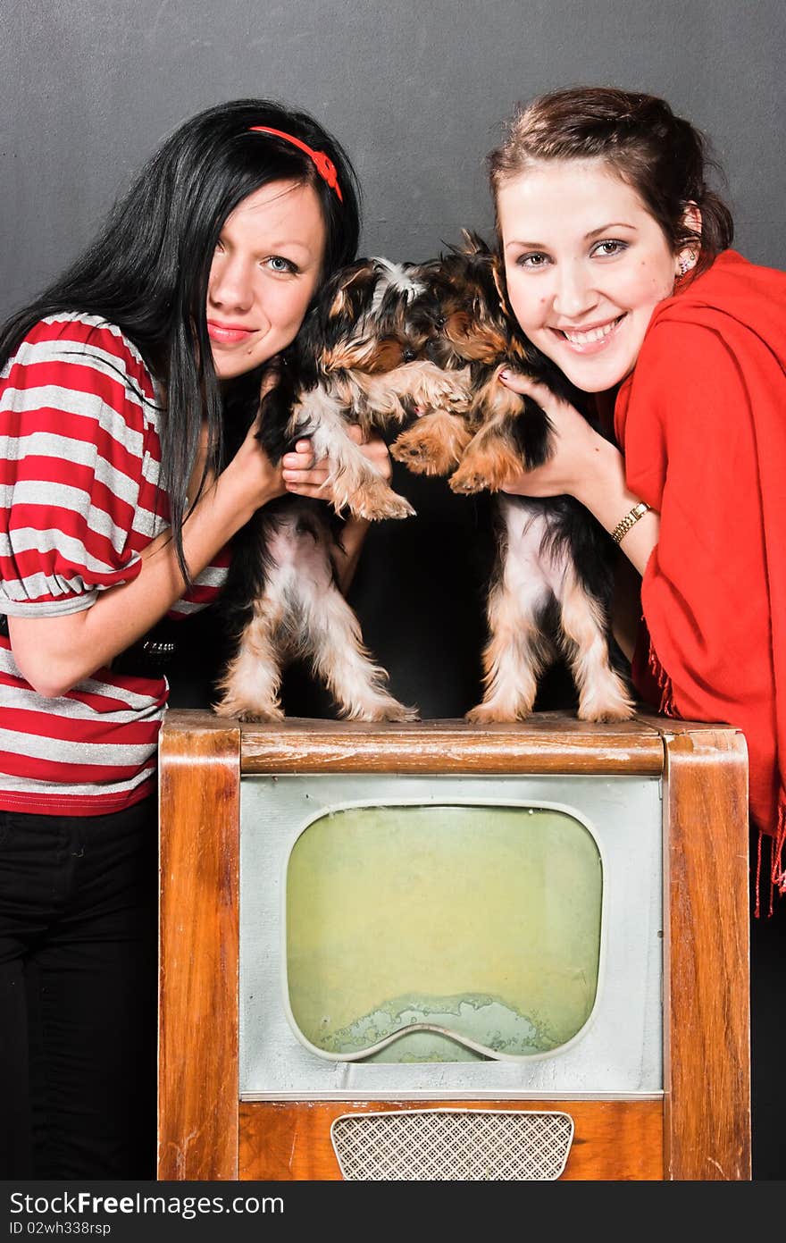 Two girls pose with terriers. Two girls pose with terriers