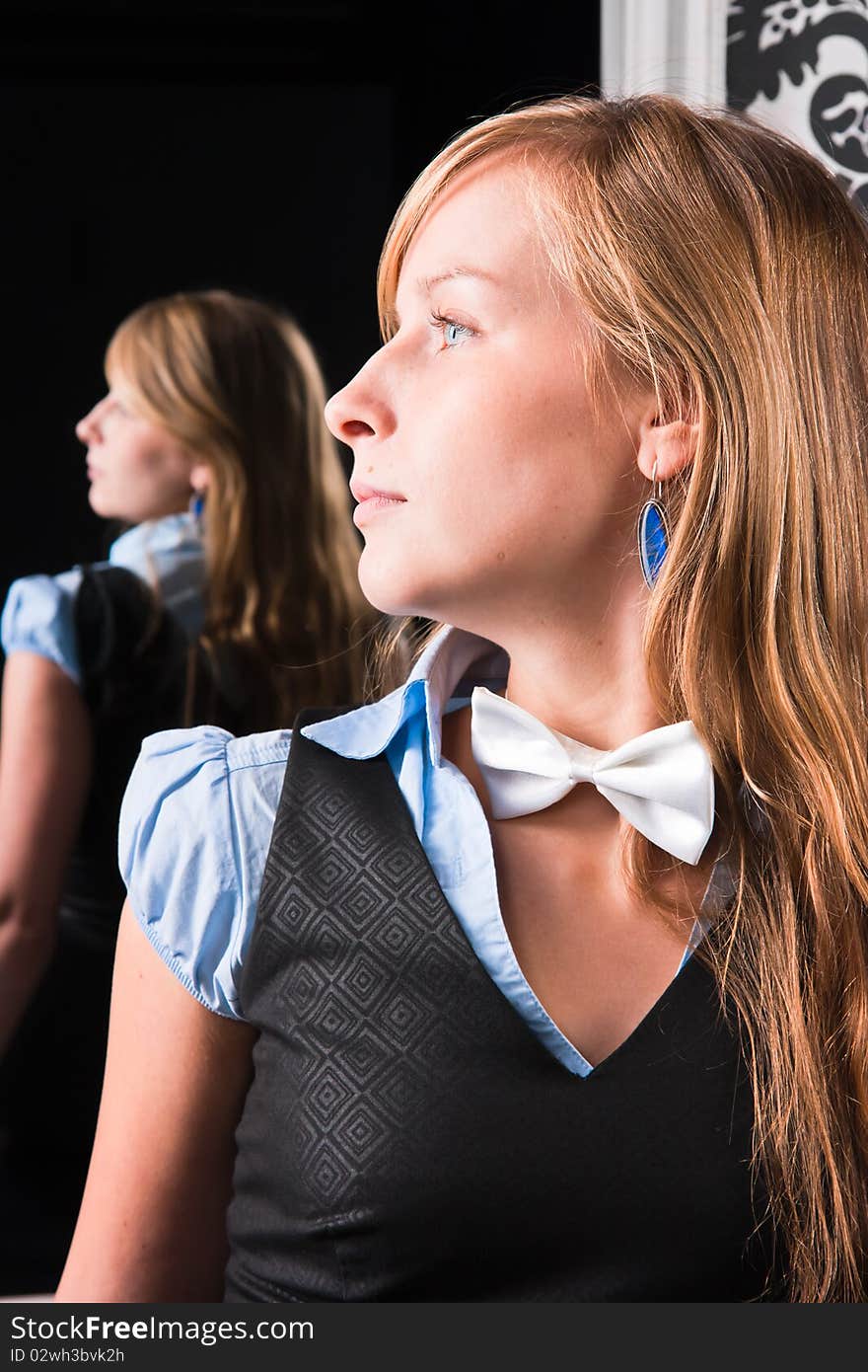 Young woman against the backdrop of mirror