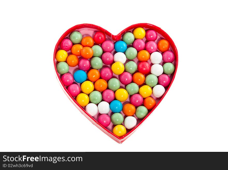 Gumballs in the shape of a heart isolated on white background