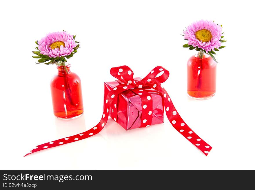 A little present between carnation flowers isolated white background