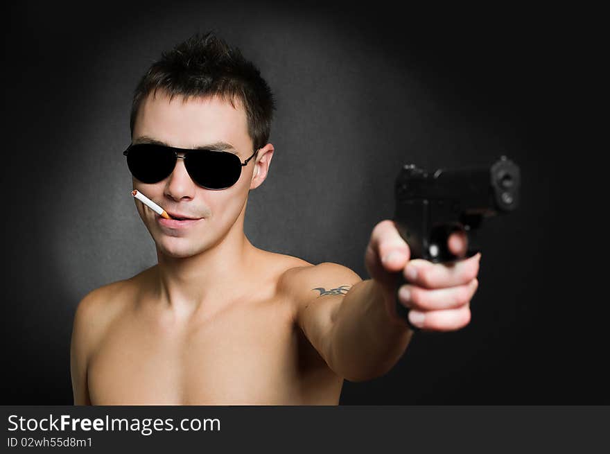 Man with gun on black