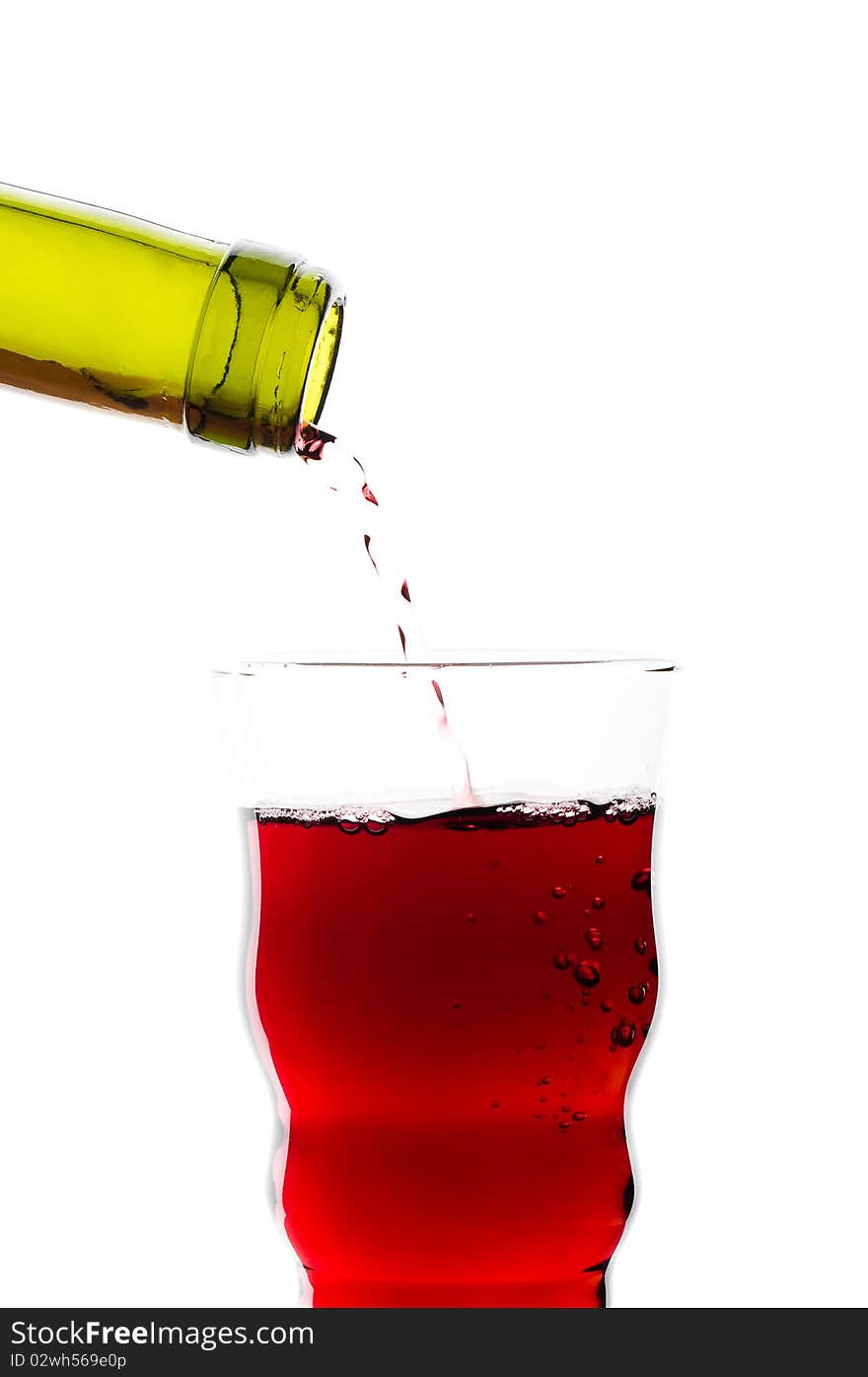 Red wine pouring into glass isolated on white