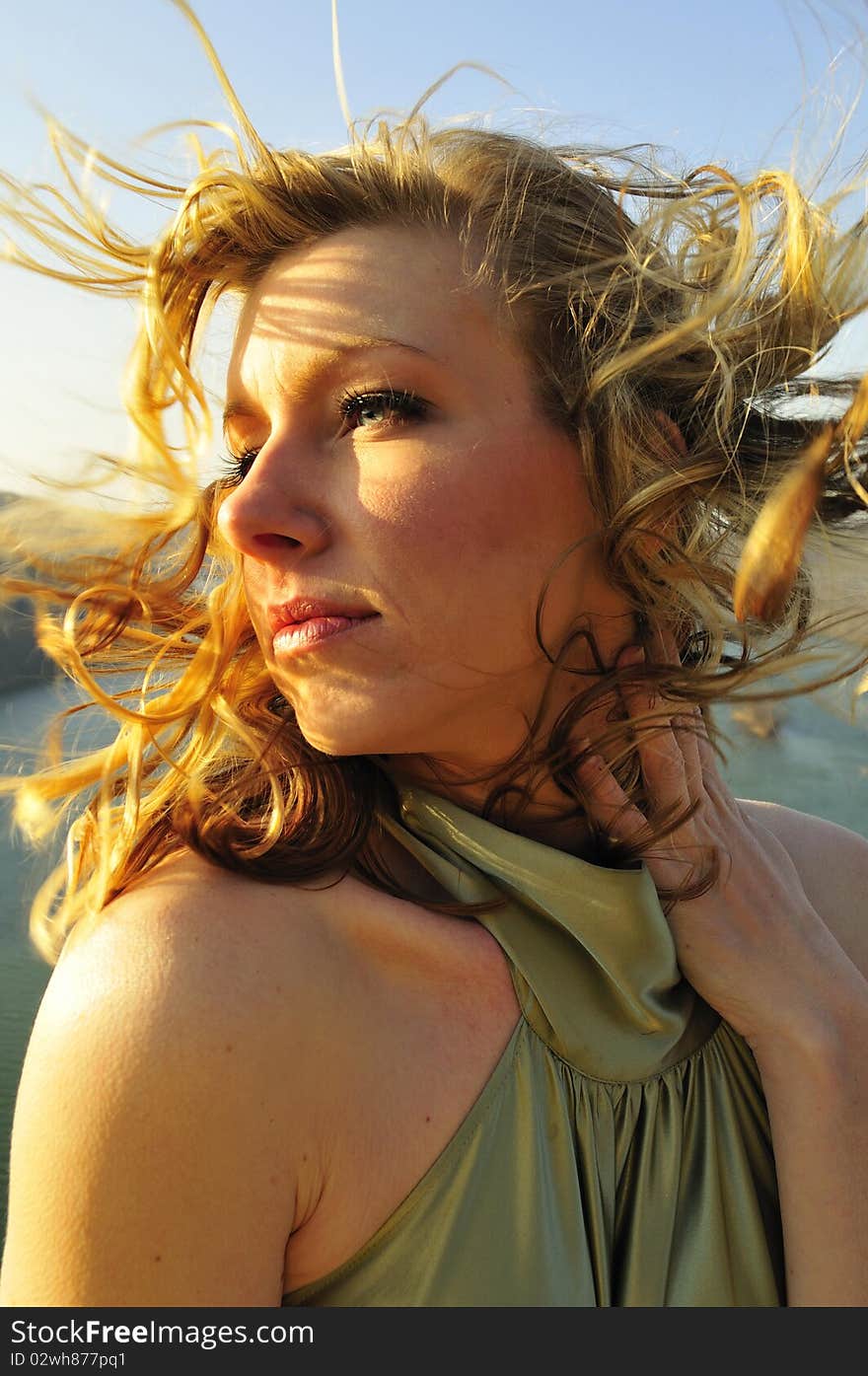 Portrait of a beautiful young woman with the wind blowing in her hair. Portrait of a beautiful young woman with the wind blowing in her hair