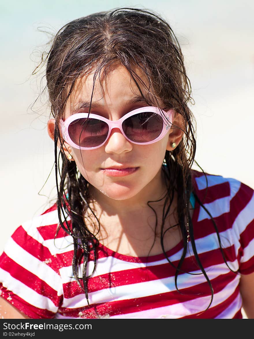 Beautiful girl with sunglasses and messy hair with a mischievous expression