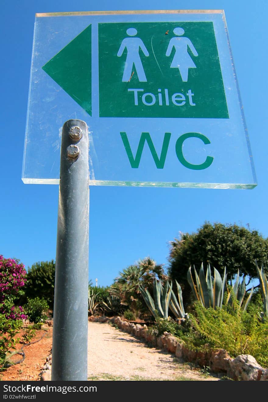 A toilet sign for ladies and gents toilets in flower garden