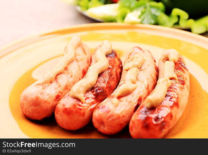 Appetizing grilled sausages on a plate. Appetizing grilled sausages on a plate.