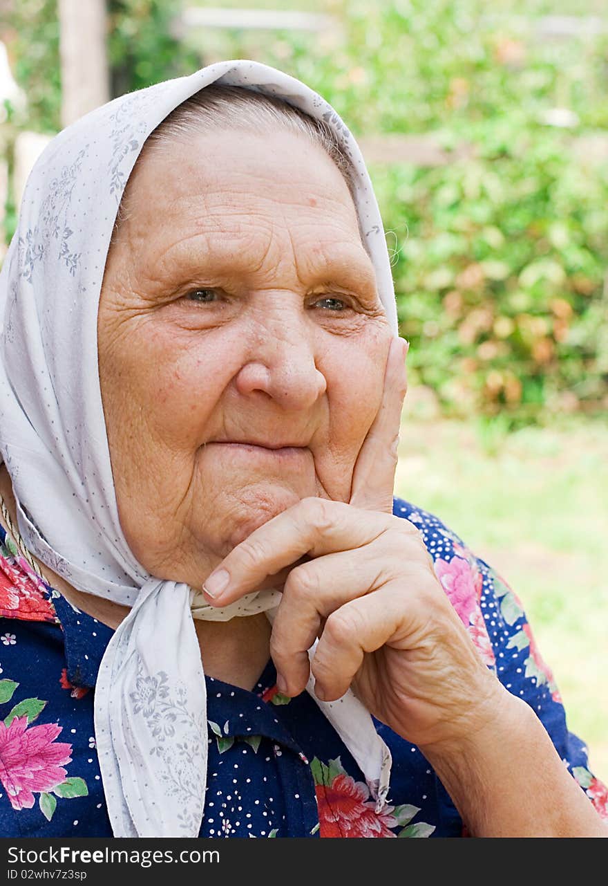 Portrait of the old woman in a scarf