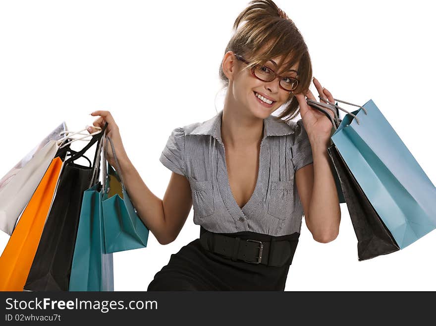 Young woman in red glasses admiring her shopping. Young woman in red glasses admiring her shopping