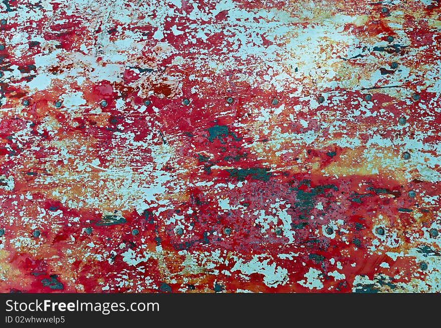 The texture of flaked red paint on metal surface. The texture of flaked red paint on metal surface
