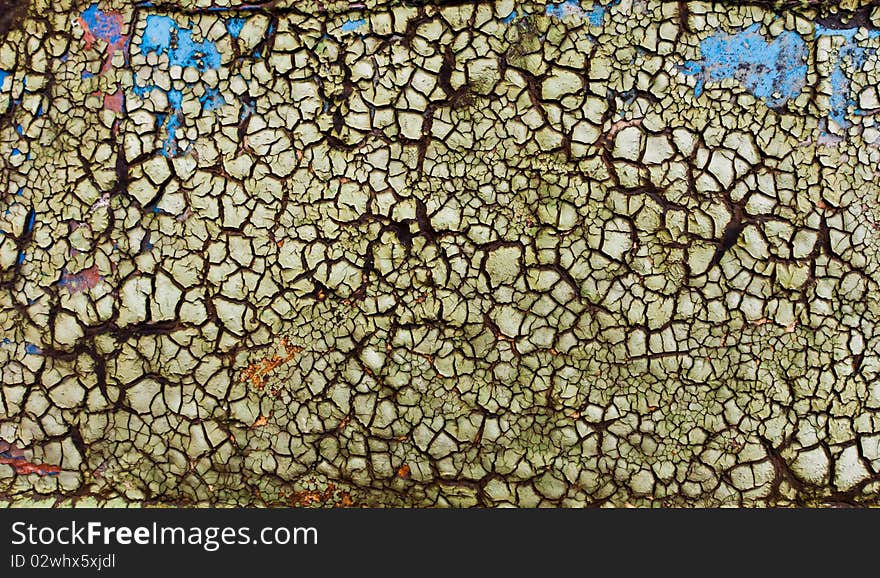 The texture of flaked green paint on wood sur