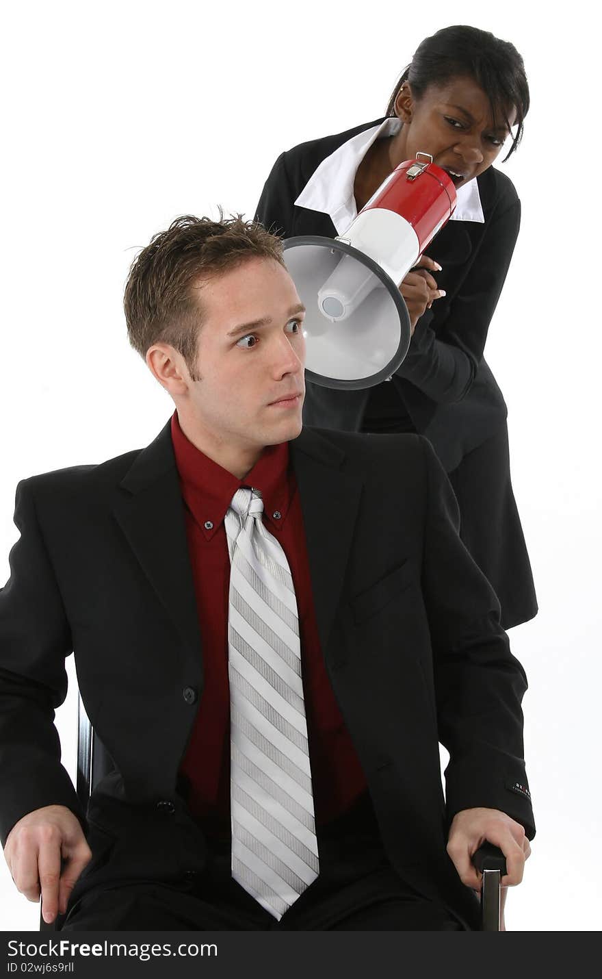 Attractive young business team over white background.  Woman yelling at man through megaphone.